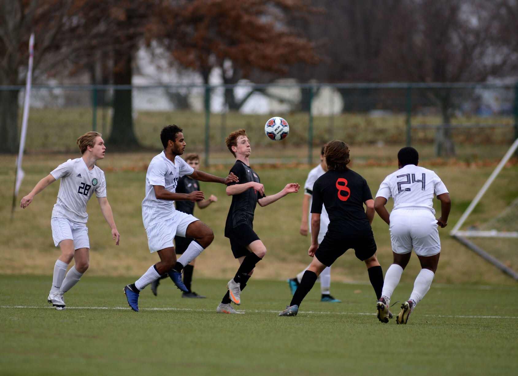Southern Boone High School and Whitfield High School players challenge to win possession of the ball